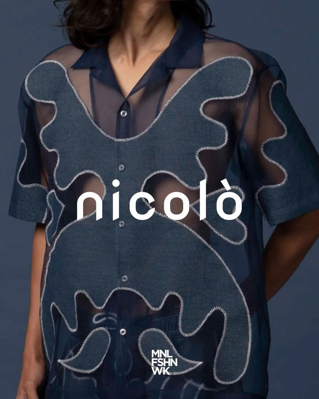 Sheer navy organza shirt by Nicolò with appliquéd denim motifs traced in white zigzag stitching