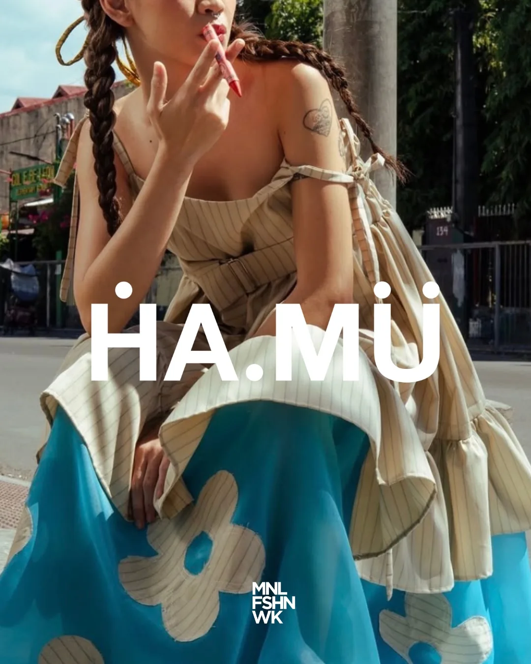 Ha.Mu. runway look built from oversized satin petals in blue, coral, white, and purple, worn with a pearl headpiece